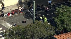 男人和孩子在学校附近过马路，被车撞伤