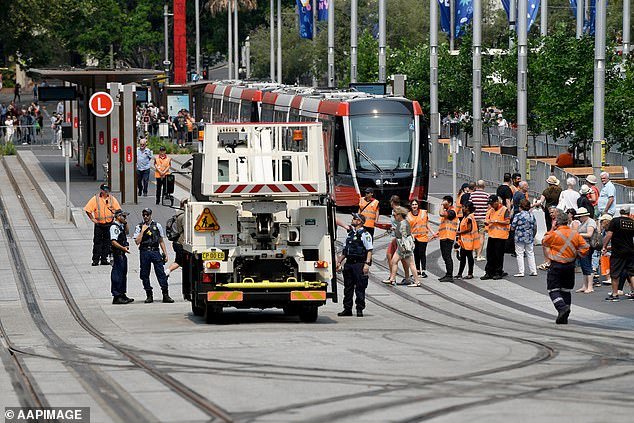 22229660-7793467-Police_and_light_rail_workers_scramble_to_fix_a_tram_pictured_af-a-28_1576375978359 (1).jpg,0