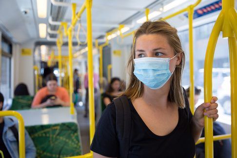 COVID-19-woman-on-tram-wearing-mask-486x324.jpg,0