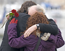 Unidentified relatives of the New Zealand plane crash victims hug after visiting the crash site. Photo / AP