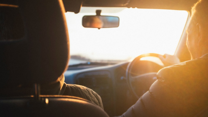 A-couple-in-the-front-seat-of-a-car-enjoying-a-safe-road-trip-while-the-sun-shines-through-the-windscreen-e1528332617356.jpg,0