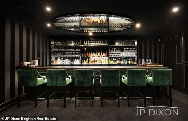 37202904-9083799-Luxe_The_home_includes_a_well_stocked_bar_area_with_plush_seats_-a-3_1608760084422.jpg,0