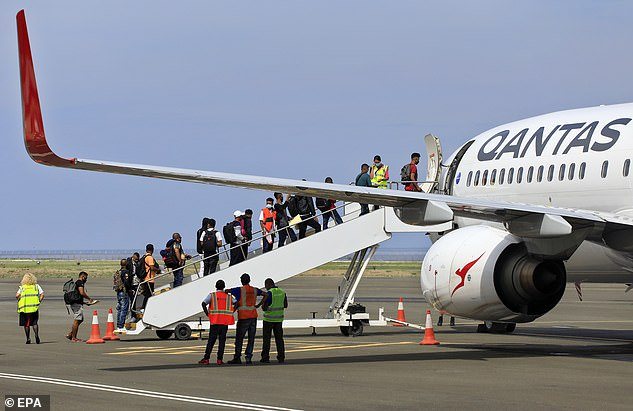 36381050-9080865-Pictured_East_Timorese_people_board_an_airplane_as_they_leave_to-a-2_1608693661729.jpg,0