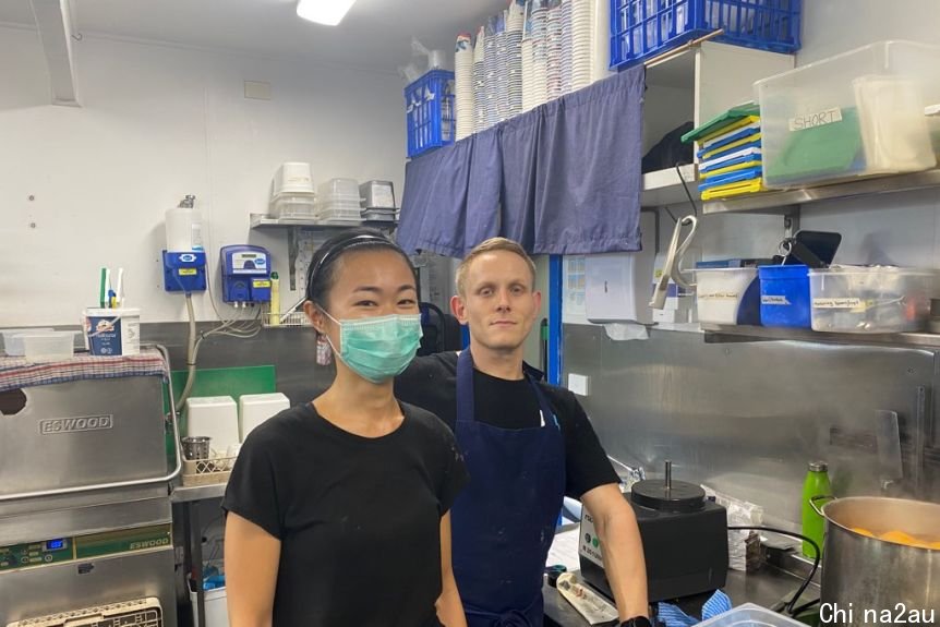 A woman and a man standing in a kitchen in NSW.