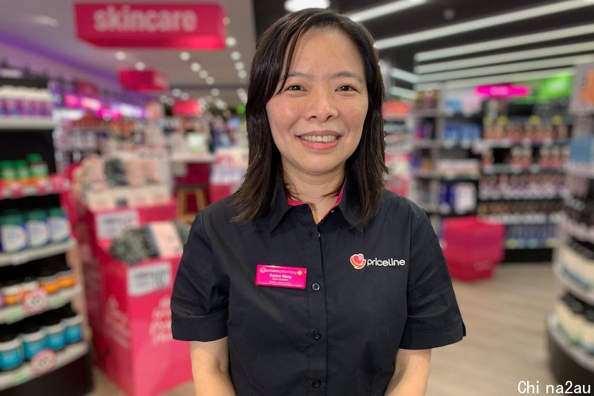 Eunice Wang works at Priceline. She is standing in the shop in her uniform.