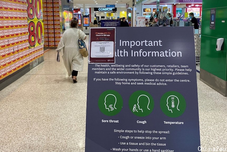 A COVID-19 warning sign inside Stockland Caloundra shopping centre