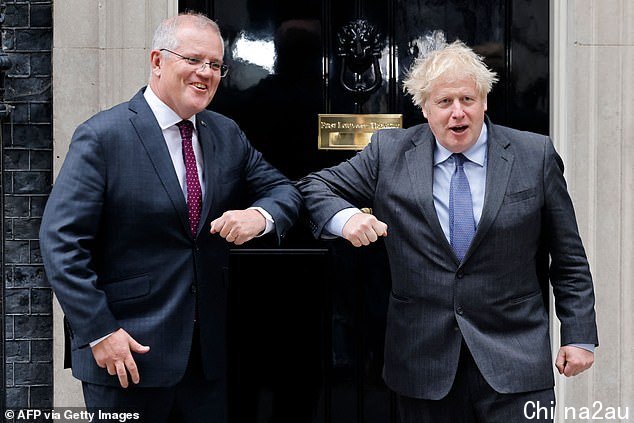 Pictured: The two leaders awkwardly touching elbows in a Covid-safe exchange on Monday