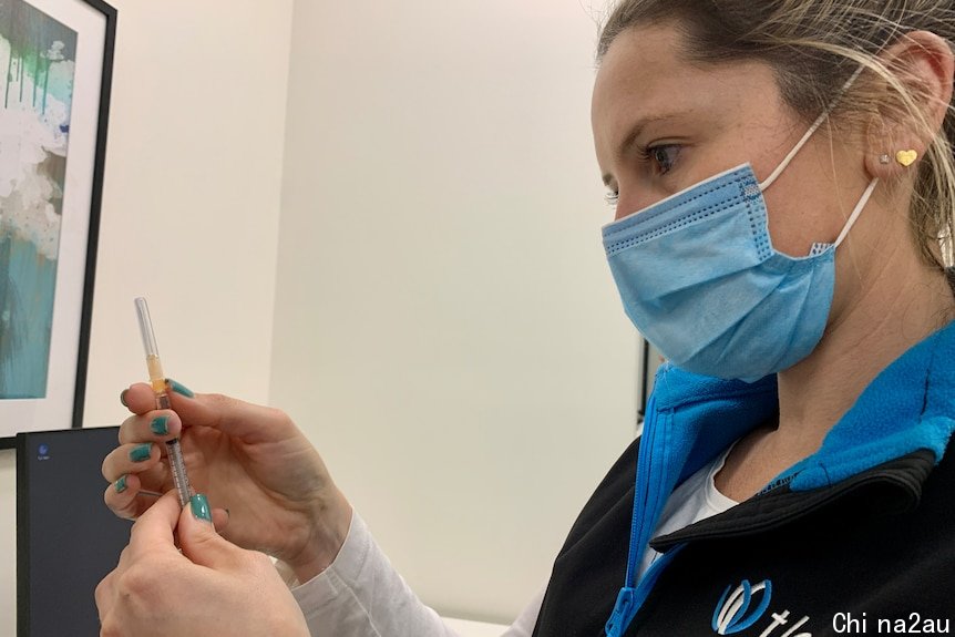 Nurse looking at a COVID vaccine