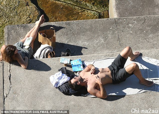 Beachgoers were spotted lazing in the sun - instead of working out - on Saturday