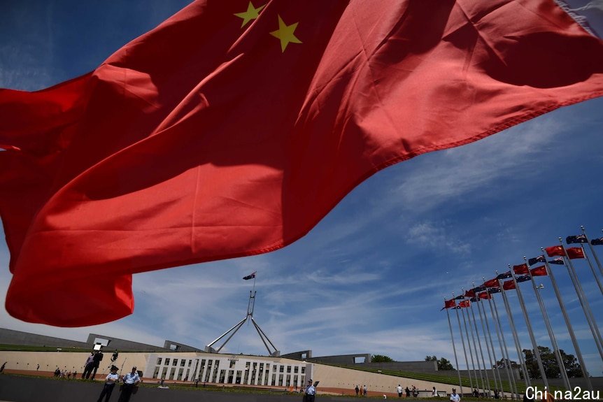 Chinese flags fly high outside the Australian Parliament House in Canberra