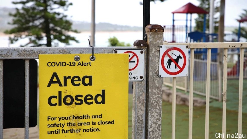 an area closed sign outside a beach playground