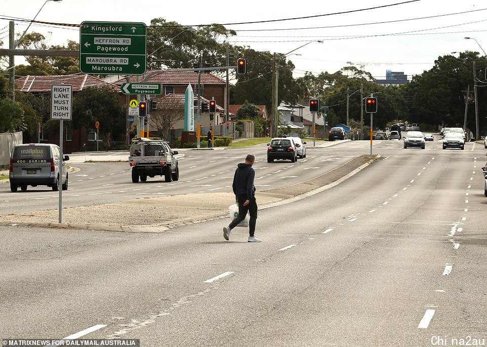 A man crosses Bunnerong Road on Wednesday, which divides Randwick Council from Bayside, an LGA 'of concern'. Randwick residents are prohibited from entering Bayside and must self isolate or risk big fines if they do