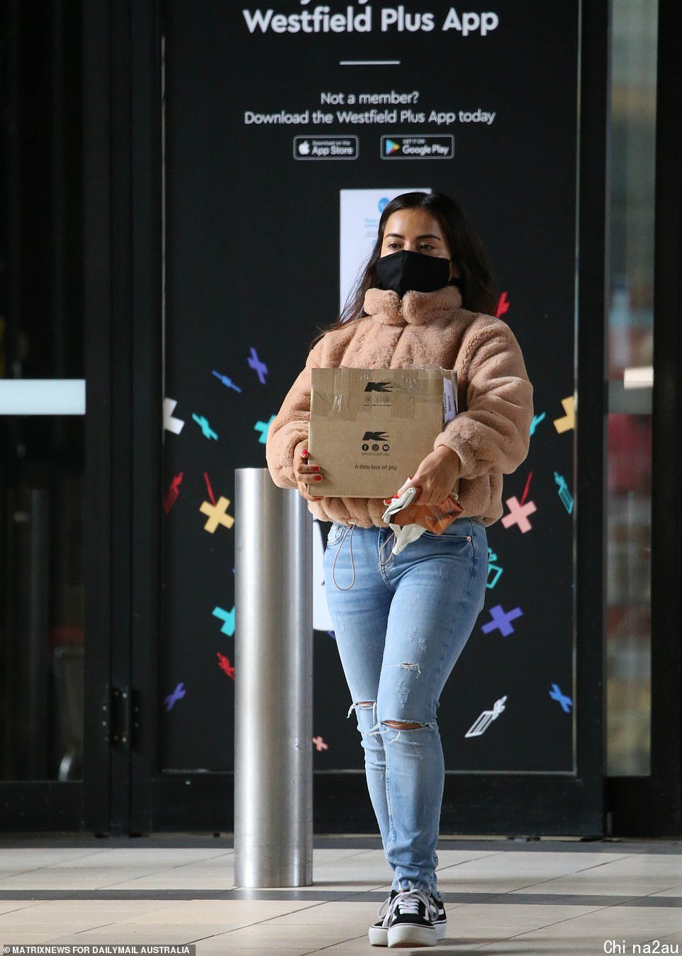A woman leaves Westfield Eastgardens - one of NSW's biggest Westfield's - with click-and-collect goods on Wednesday (pictured)