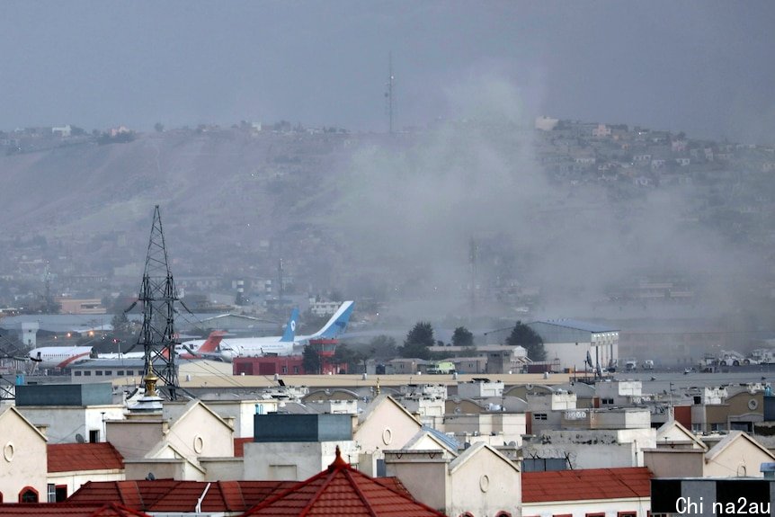 Smoke rises from a deadly explosion outside the airport in Kabul