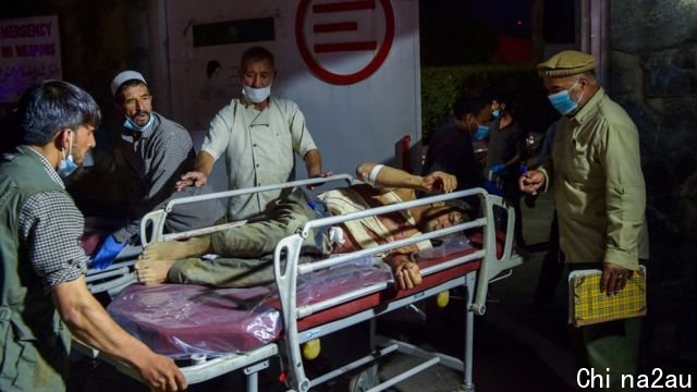 Hospital staff bring an injured man for treatment after the Kabul airport attack