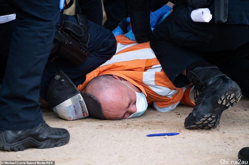 One man is held down by police in Melbourne during a failed anti-lockdown protest on Tuesday