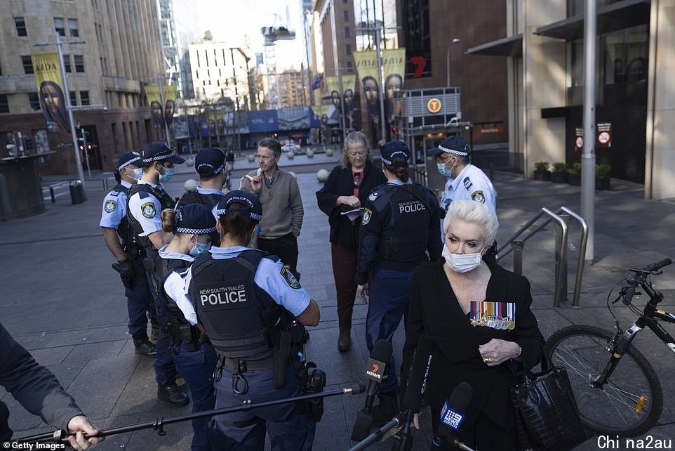 Police speak to a group of protesters that gathered together in Martin Place in Sydney on Tuesday