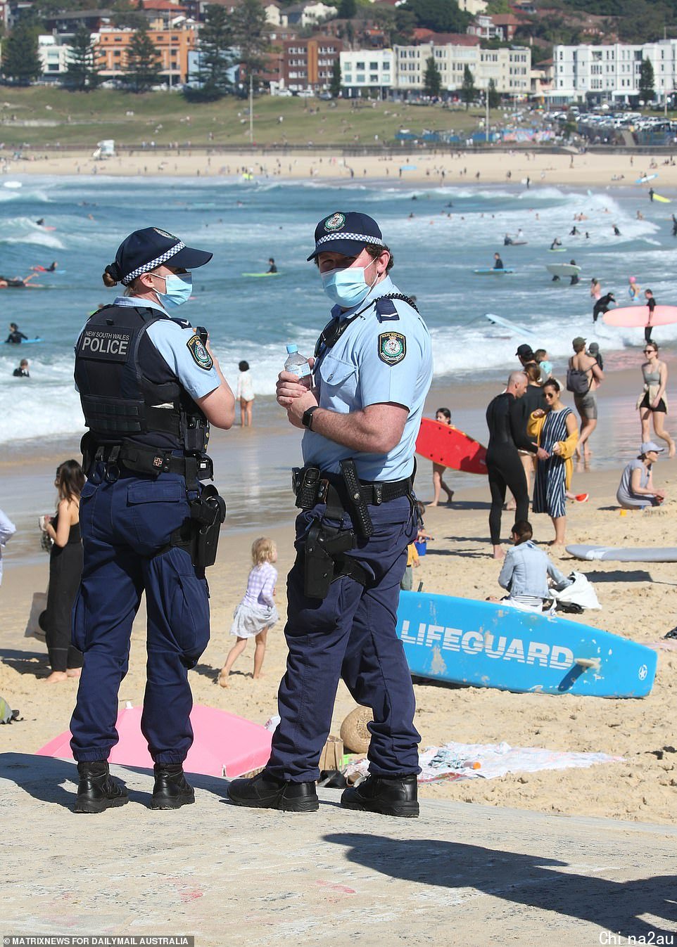 Masked officers were seen down in Bondi on Saturday as thousands hit the waves