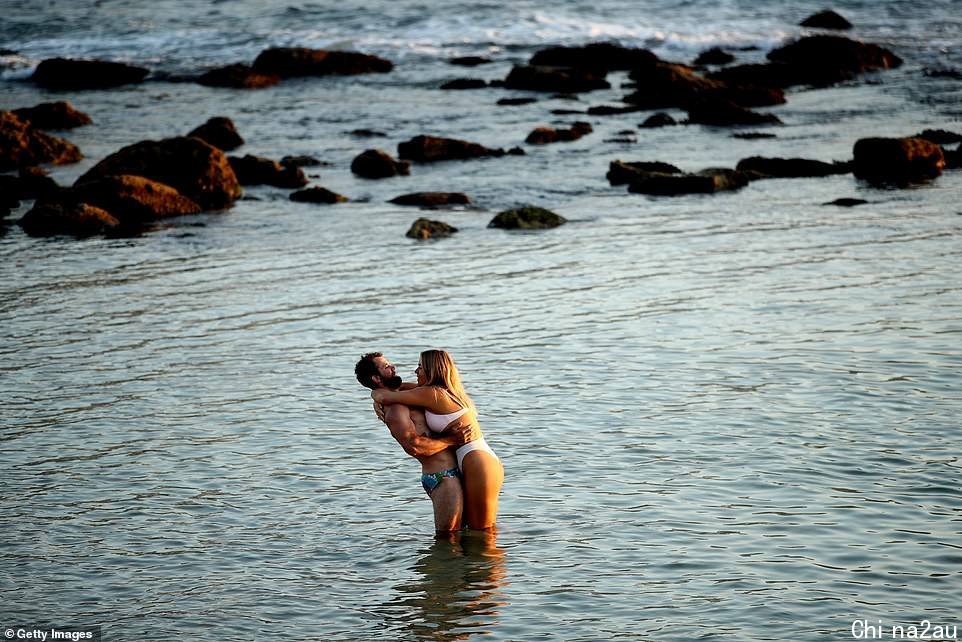 A couple are seen swimming at Bronte Beach in Sydney's east early on Saturday morning