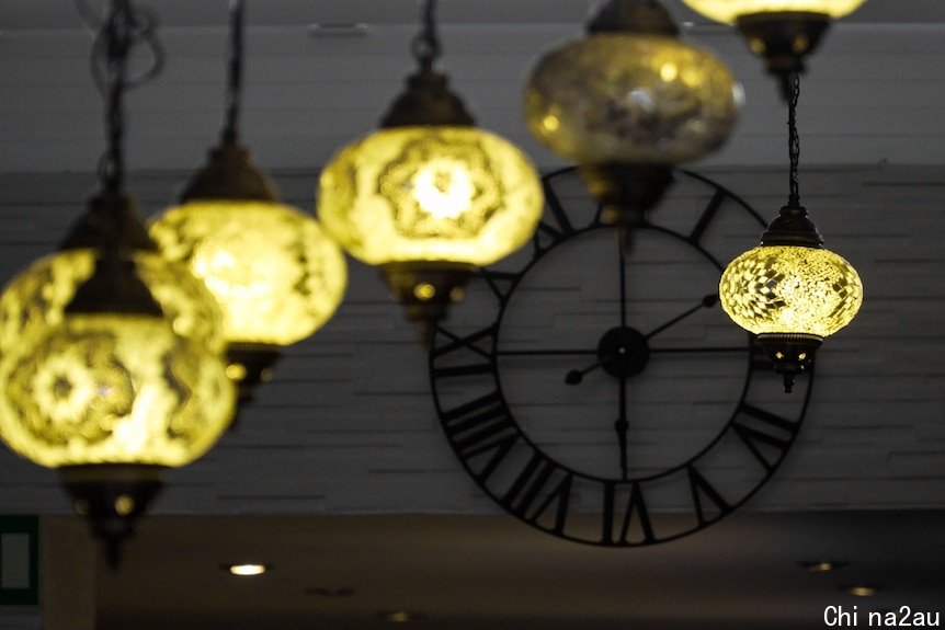 A wall clock and ornamental light fittings