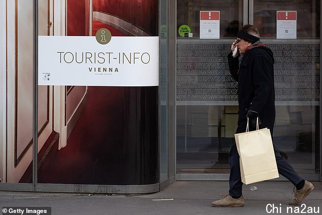 More than 4,000 are dying every day across Europe at the moment with Russia, Germany, Romania, Poland, Austria and the Netherlands among the worst hit (pictured, a man walks past a closed tourist information office in Austria during the fresh lockdown)