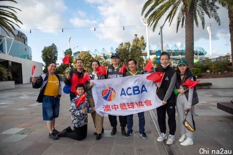 A group of people holding a sign

Description automatically generated