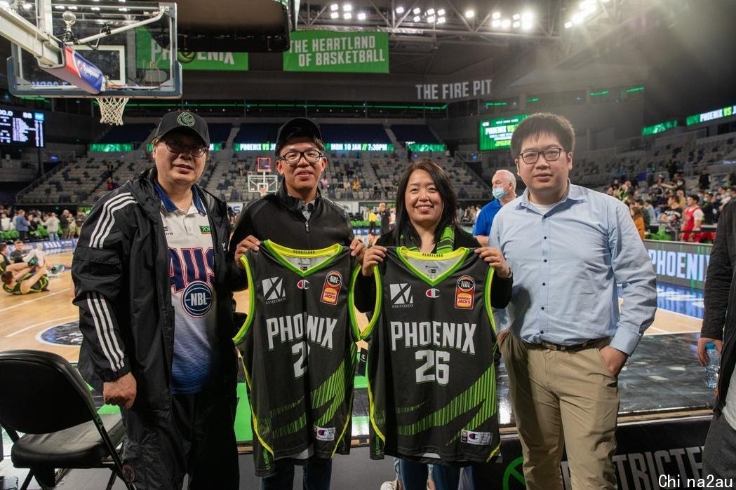 A group of people posing for a photo in a stadium

Description automatically generated with medium confidence