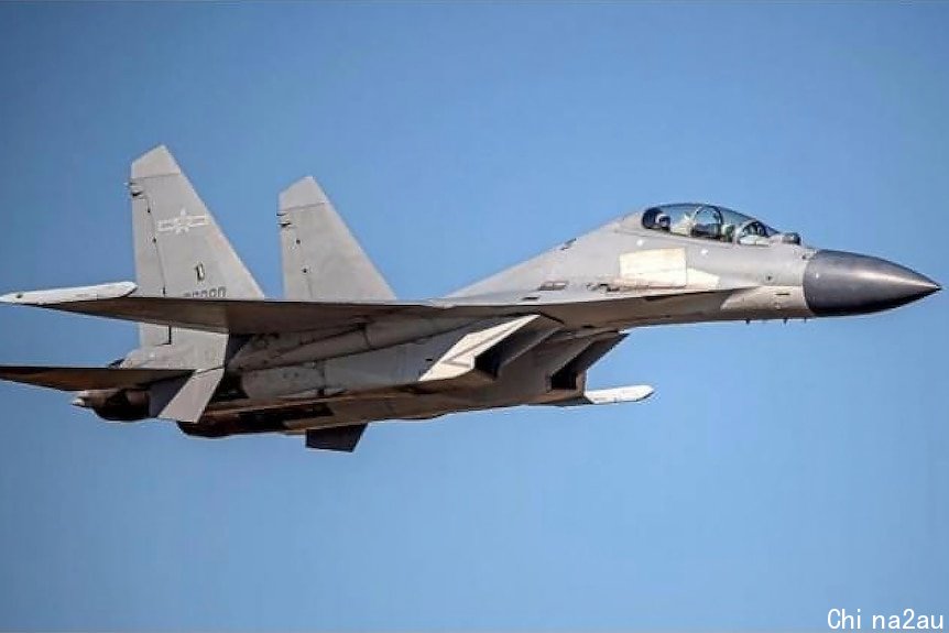 A fighter jet against a blue sky.