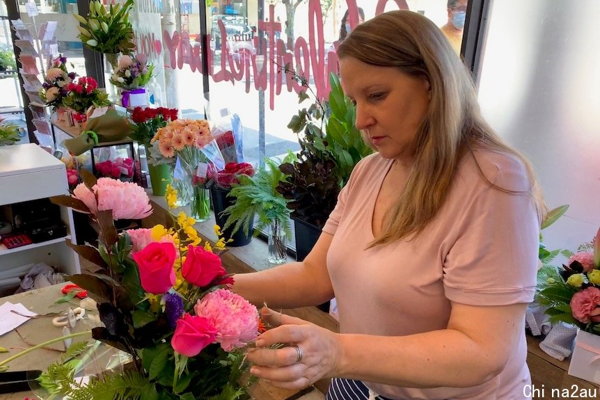 Florist Judy Ann Thomas arranges flowers.