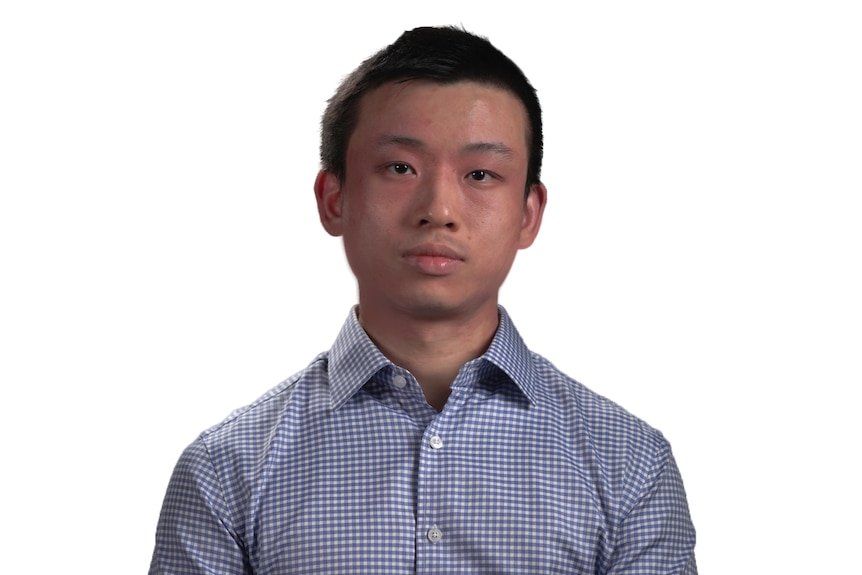 A headshot of a man wearing blue check button-up shirt against a white background