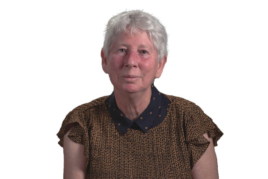 A headshot of a woman wearing a brown spotted top against a white background