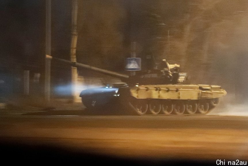 A tank drives along a street in Donetsk