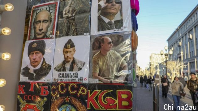 Photos of Russian President Vladimir Putin are displayed at a souvenir shop in downtown Moscow, Russia, 25 February 2022