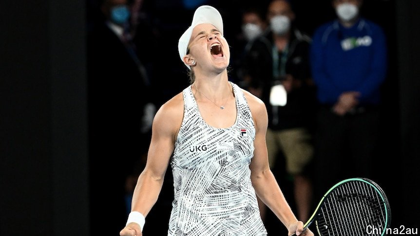 Ash Barty screams with both fists clenched, one around a tennis racket, after winning the Australian Open final.