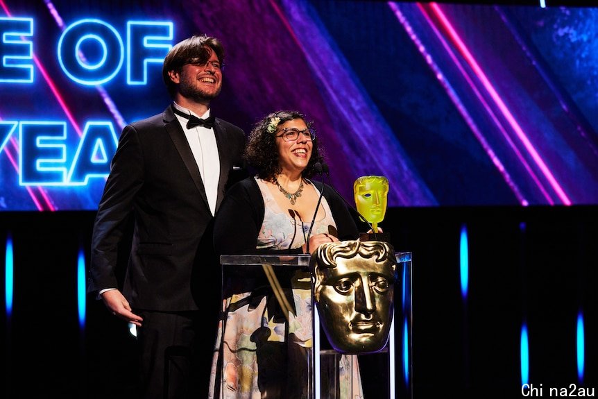 Tim Dawson and Wren Brier on stage at the BAFTAs after winning. 