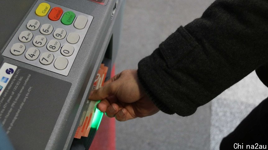 Man takes cash from ATM