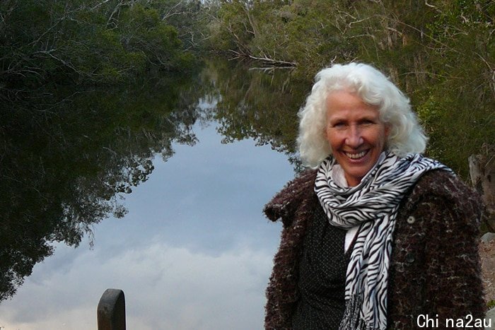 Caroline Sullivan smiling against river backdrop