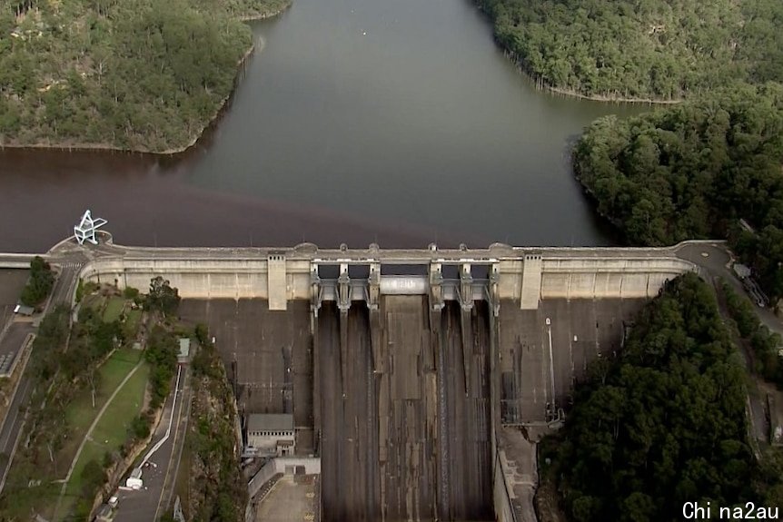 The Warragamba Dam from a helicopter above surrounded by trees