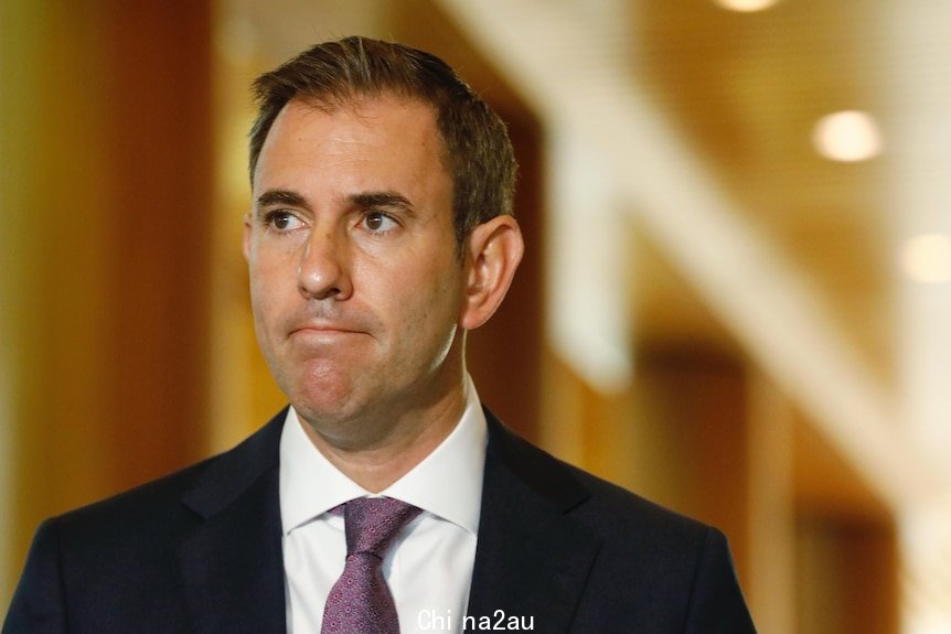 Jim Chalmers looking to the right in a suit and wearing a purple tie