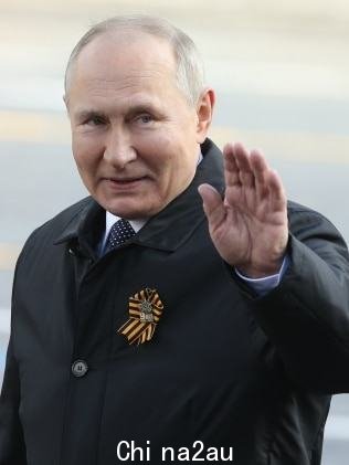Russian President Vladimir Putin waves during the Victory Day Parade at Red Square on May 9. Picture: Getty Images.