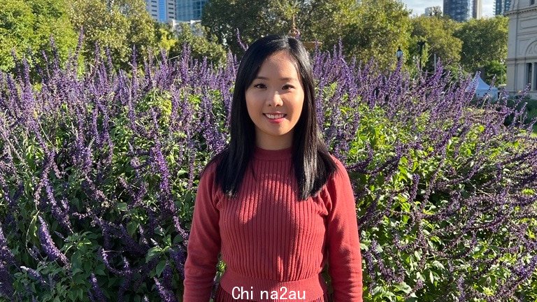 A profile image of Irene Teo with red dress, long lack straight hair, smiling, in front of purple flowered bush