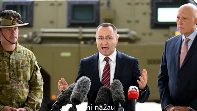 Ukrainian Ambassador Vasyl Myroshnychenko (centre) with then-defence minister Peter Dutton in Ipswich in April following the government's announcement that it would send 20 Bushmasters to the war-zone in Ukraine. Picture: Getty Images