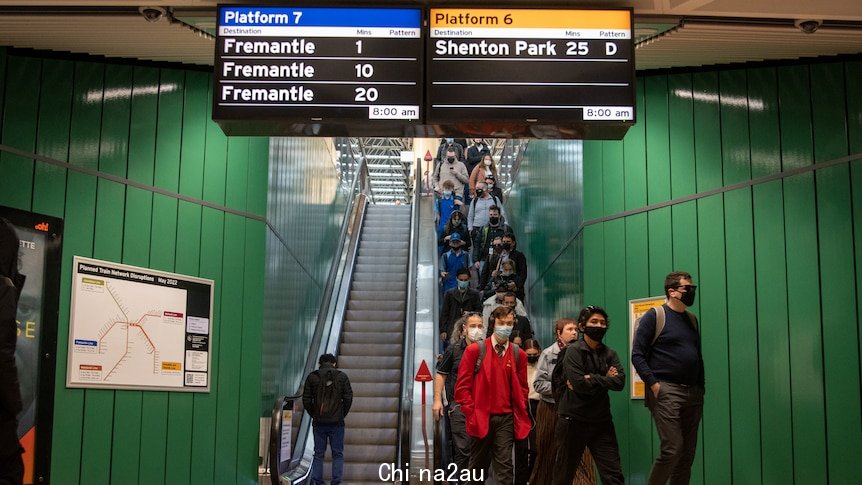 People wearing masks as they come down the escalator in the Perth underground