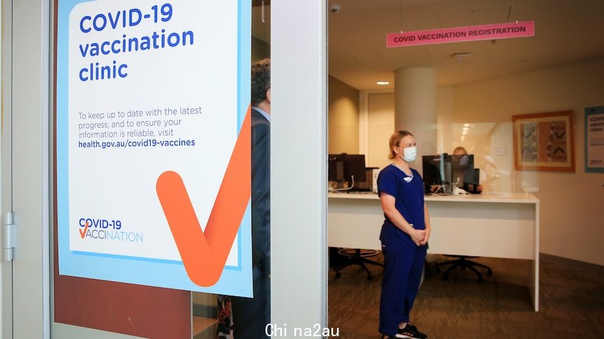 A nurse stands waiting in an empty COVID-19 clinic.