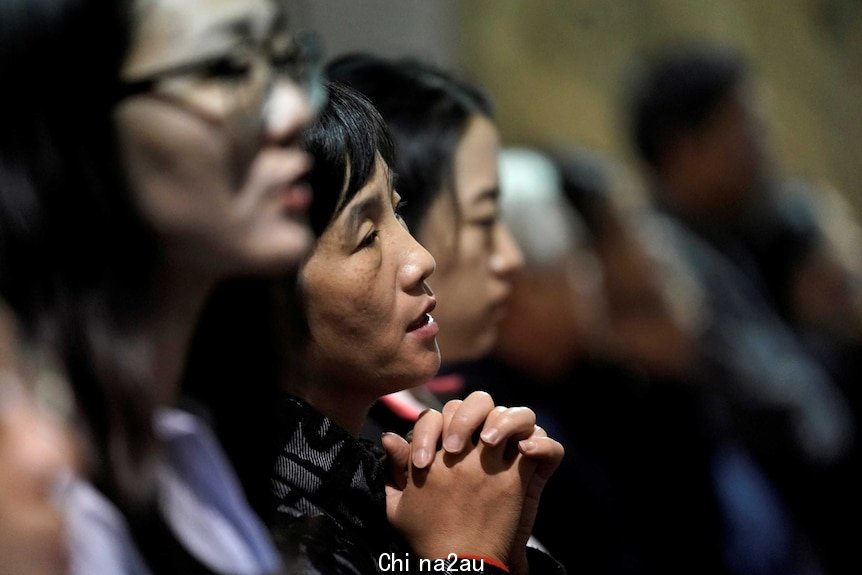 Believers take part in a weekend mass at Beijing South Catholic Church in Beijing