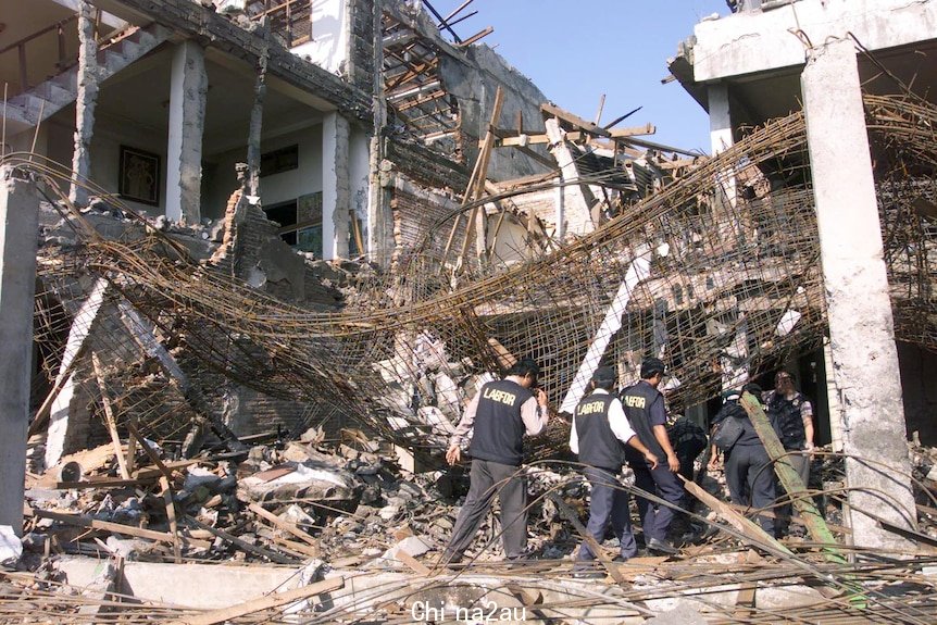 A building stands burnt out with its scaffolding exposed at the site of the bombing in Kuta beach, Bali, October 2003.