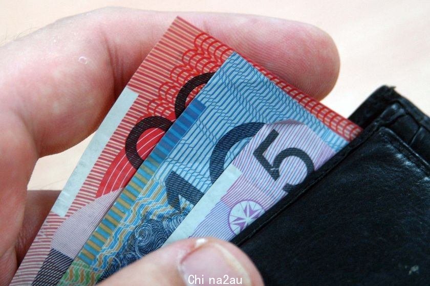 man taking Australian notes out of a wallet