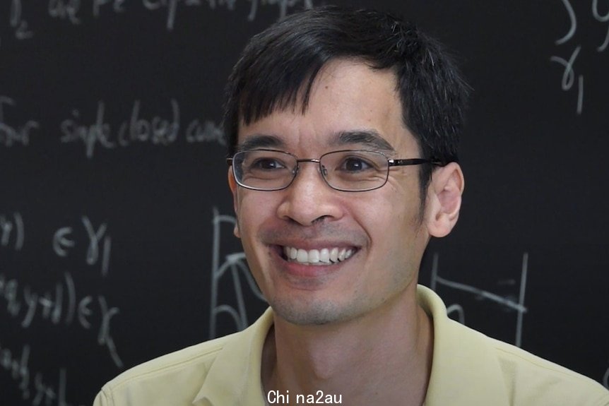 Mathematician Terry Tao in front of a blackboard.