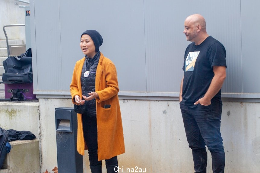 A Chinese-Indonesian woman stands next to a man in a Smoking Ceremony.