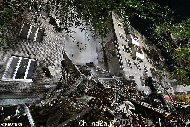 ZAPORIZHZHIA：救援人员试图扑灭乌克兰南部一栋公寓楼的残骸，该建筑在一夜之间被俄罗斯导弹击中
